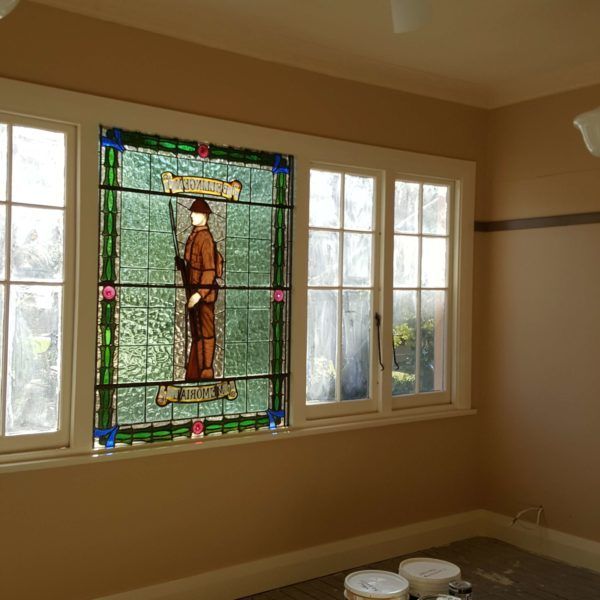 A stained glass window with a freshly painted trim and walls — Axis Painting in Coffs Harbour, NSW