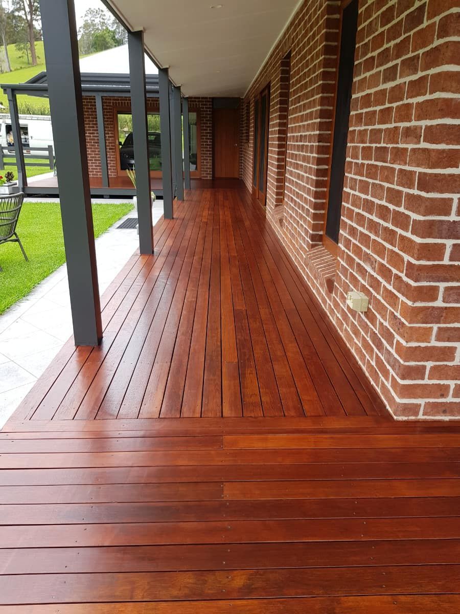 A wooden deck with a brick wall in the background — Axis Painting in Coffs Harbour, NSW