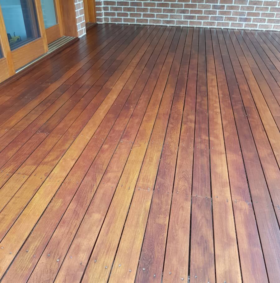 A wooden deck with a brick wall in the background — Axis Painting in Coffs Harbour, NSW