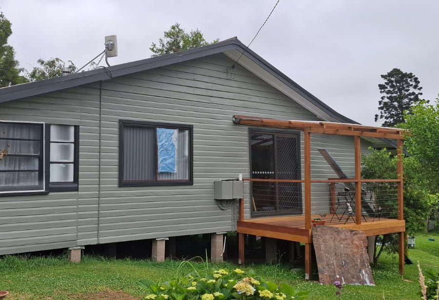 A small house with a wooden deck in front of it — Axis Painting in Coffs Harbour, NSW