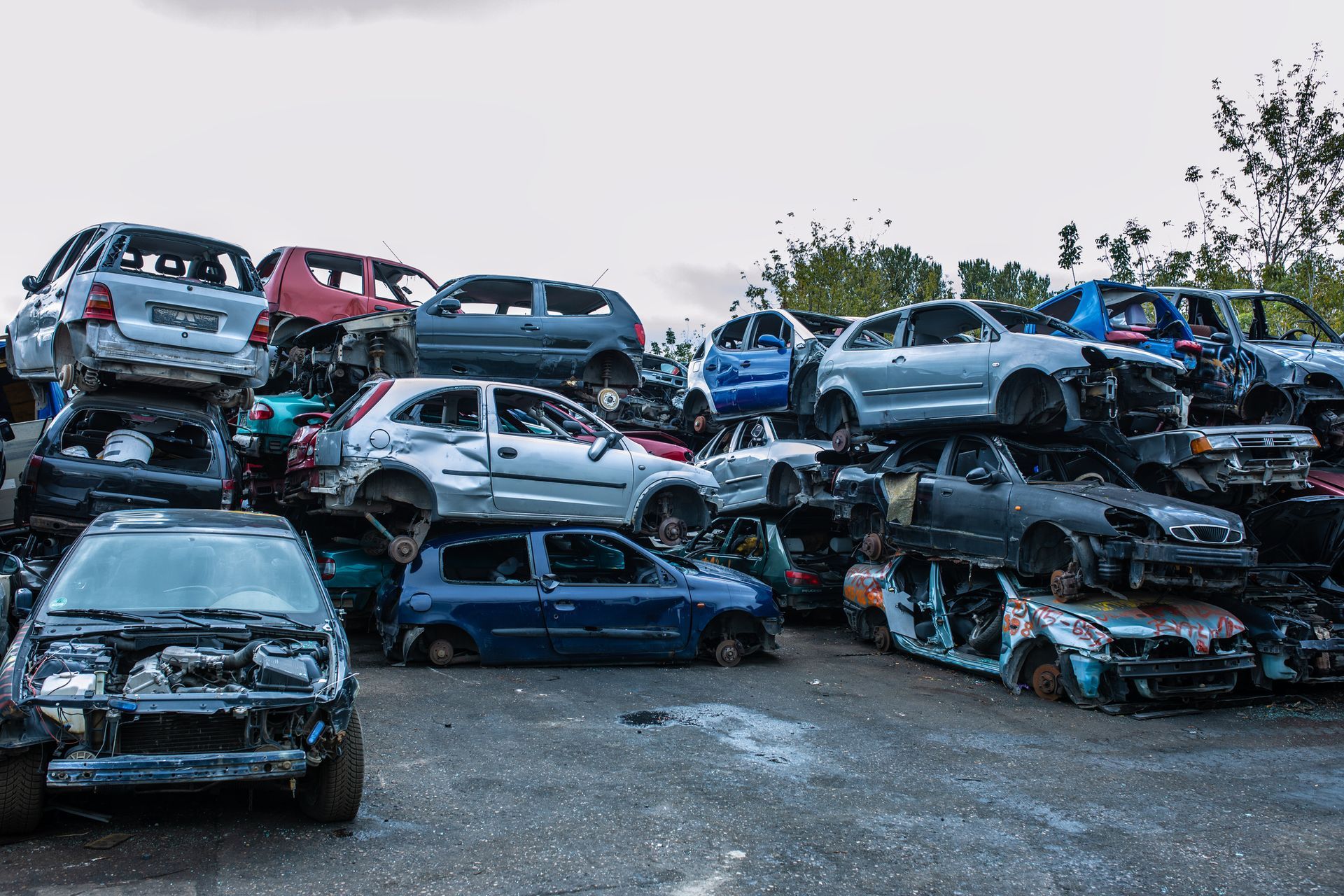 Stacked scrapped cars in a recycling yard show the process of dismantling old vehicles.