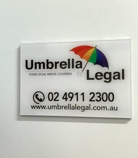 Umbrella Legal sign with rainbow umbrella logo, phone number 02 4911 2300, and website URL.