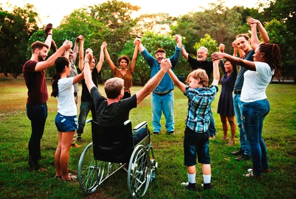 A Diverse Group of People in a Circle on Grass — Umbrella Legal in Cardiff, NSW