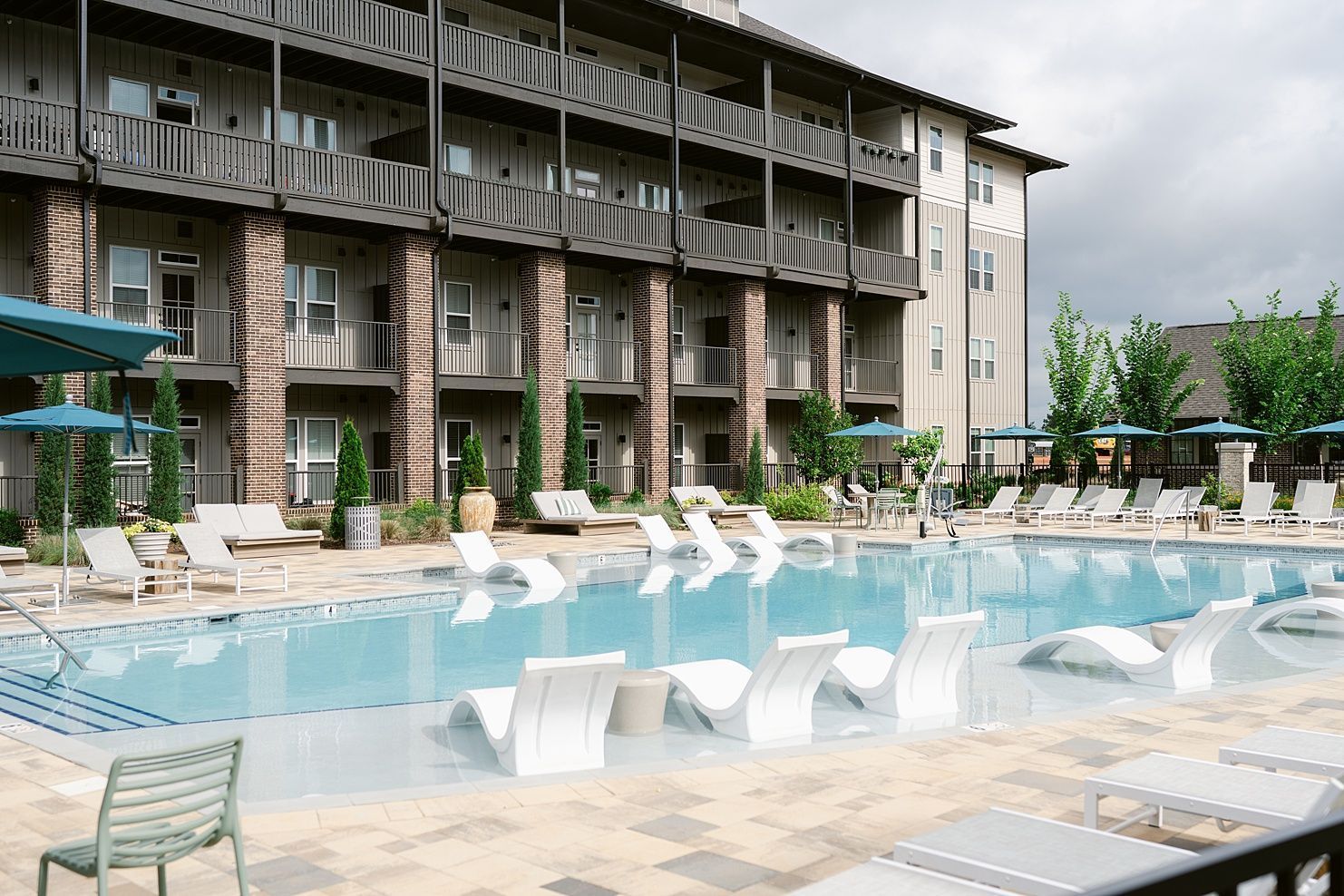 Lounge chairs on the sundeck of the swimming pool at Livano at Town Madison.