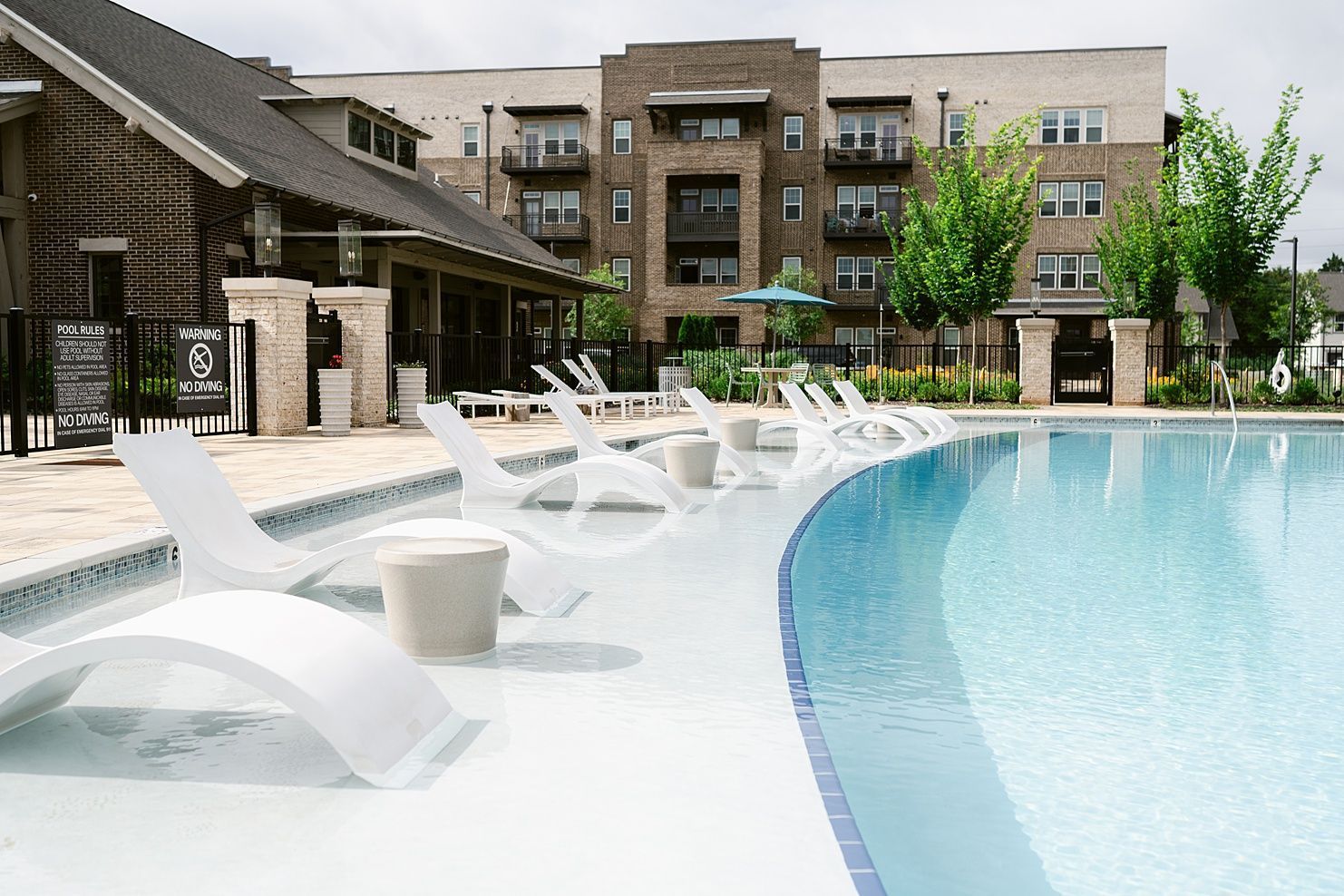 Lounge chairs on the sundeck of the swimming pool at Livano at Town Madison.