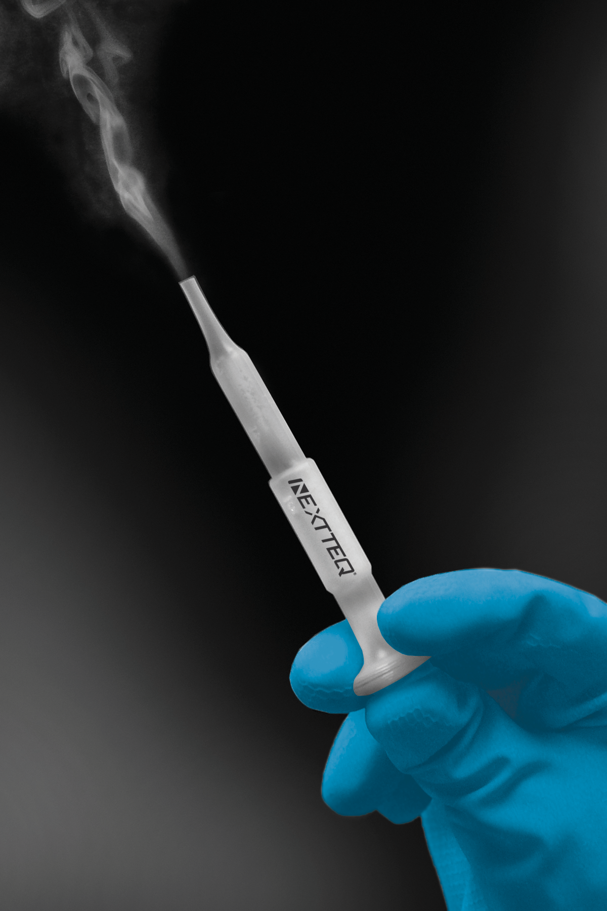 A hand demonstrating how to use the Nextteq® VeriFit® Irritant Smoke Generator. Step 3. Compress the bellows and smoke is generated.