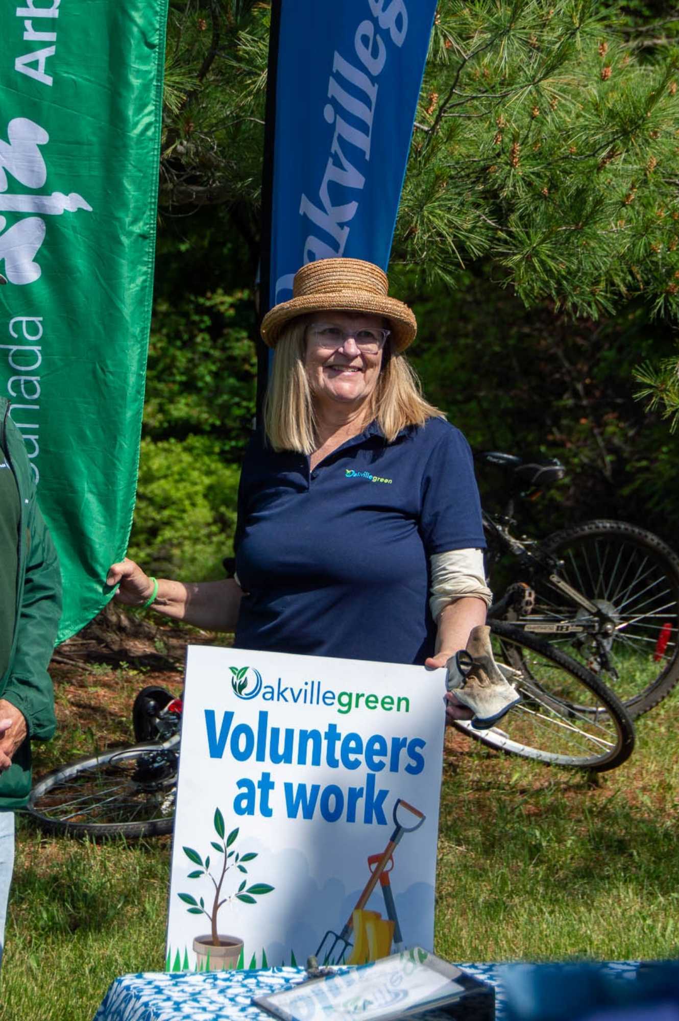 Karen Brock at a recent Oakvillegreen event with a sign reading 