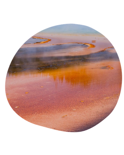 Circular view of a pink-orange salt lake with blue water and distant shoreline