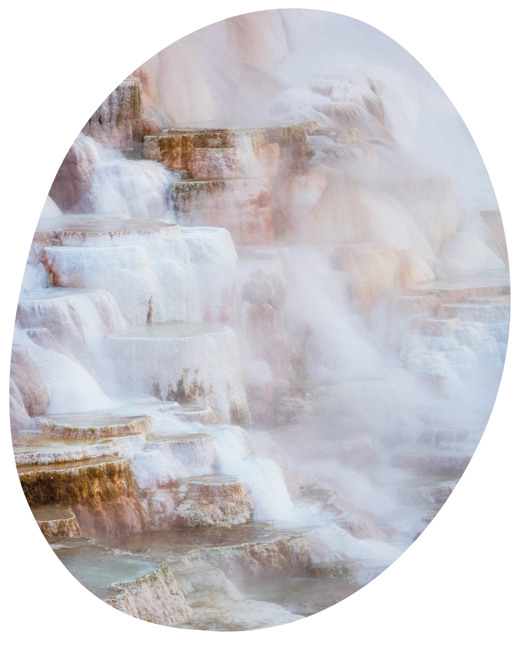 Soft-focus waterfall cascading over layered rocks in pale beige and white tones