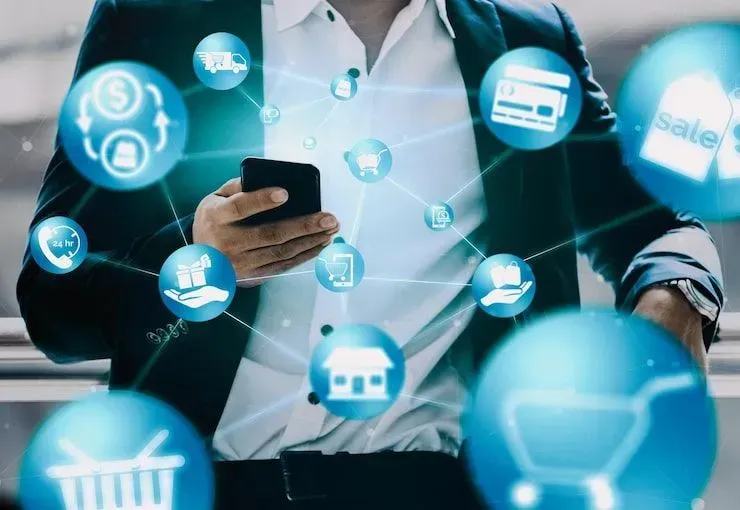 Person using a smartphone with floating blue e-commerce and social media icons