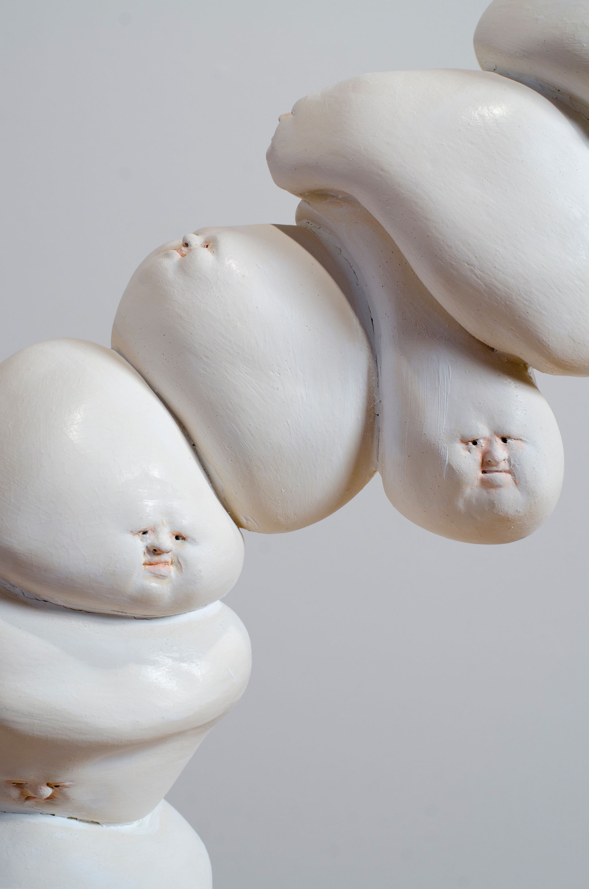White meringue cookies stacked in a close-up on a light gray background