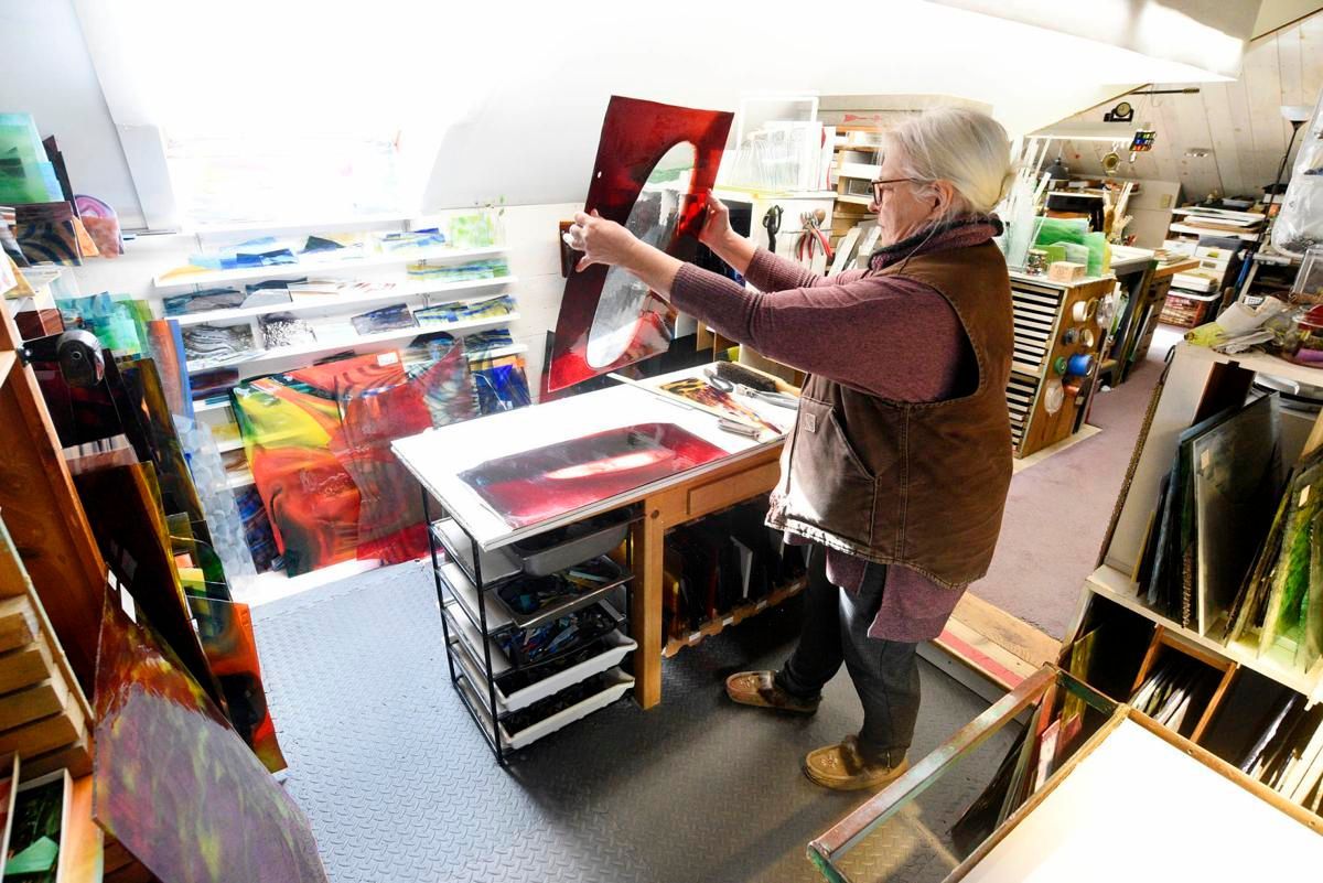 Person in an art supply shop browsing colorful canvases and frames on display.