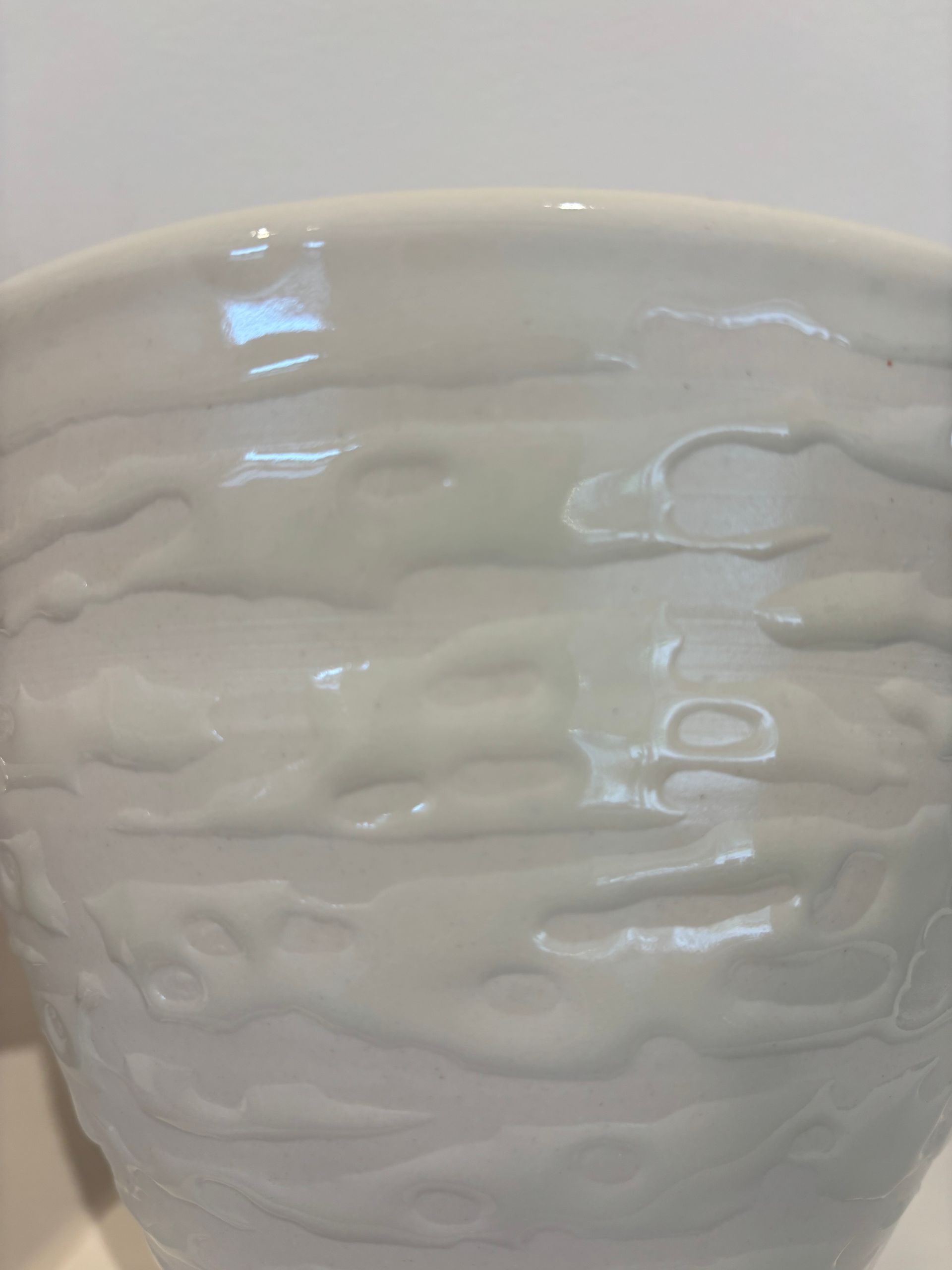 White embossed ceramic bowl with wavy texture on a light background
