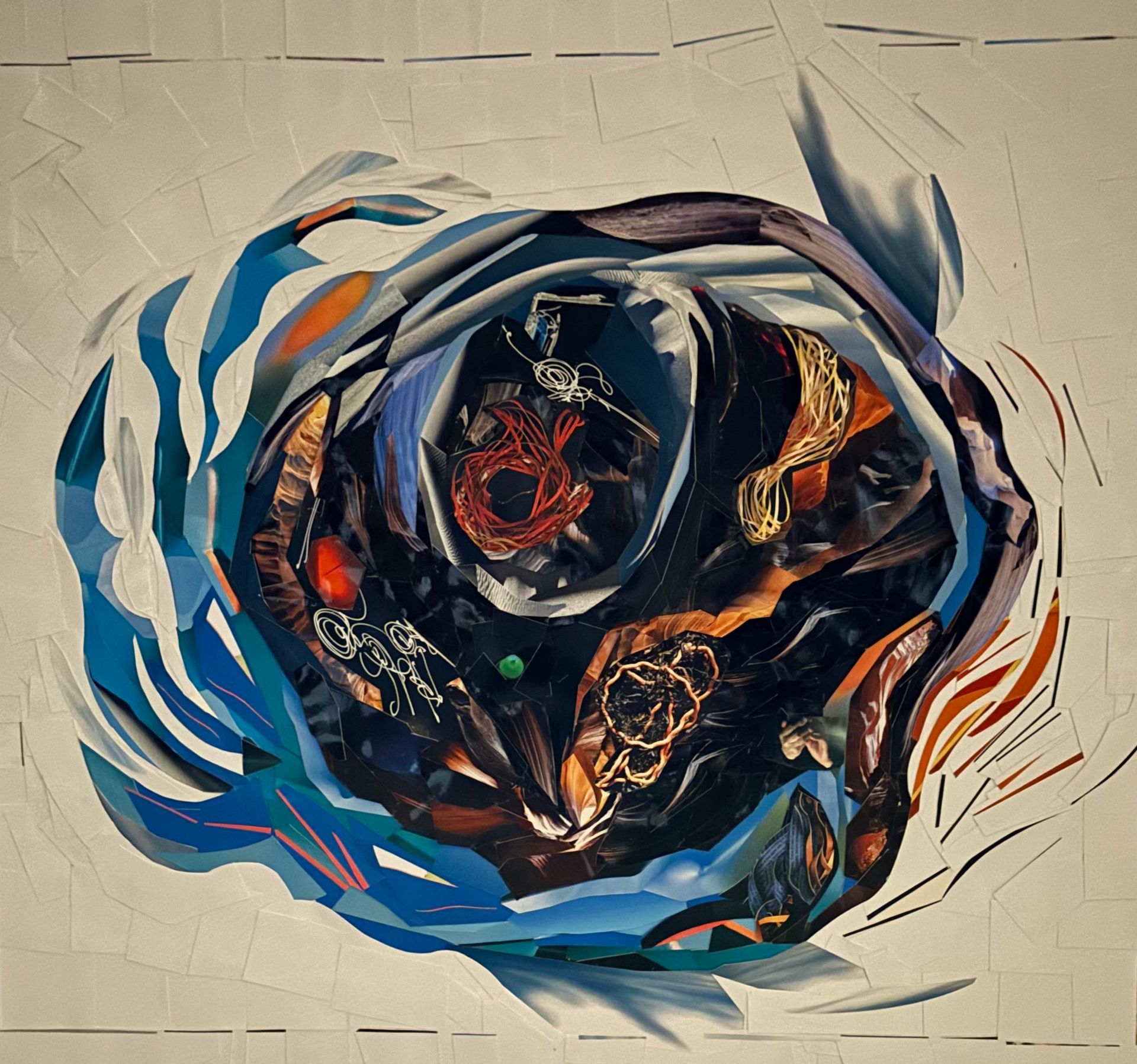 Abstract swirling circular artwork in blue, black, and orange on a beige background