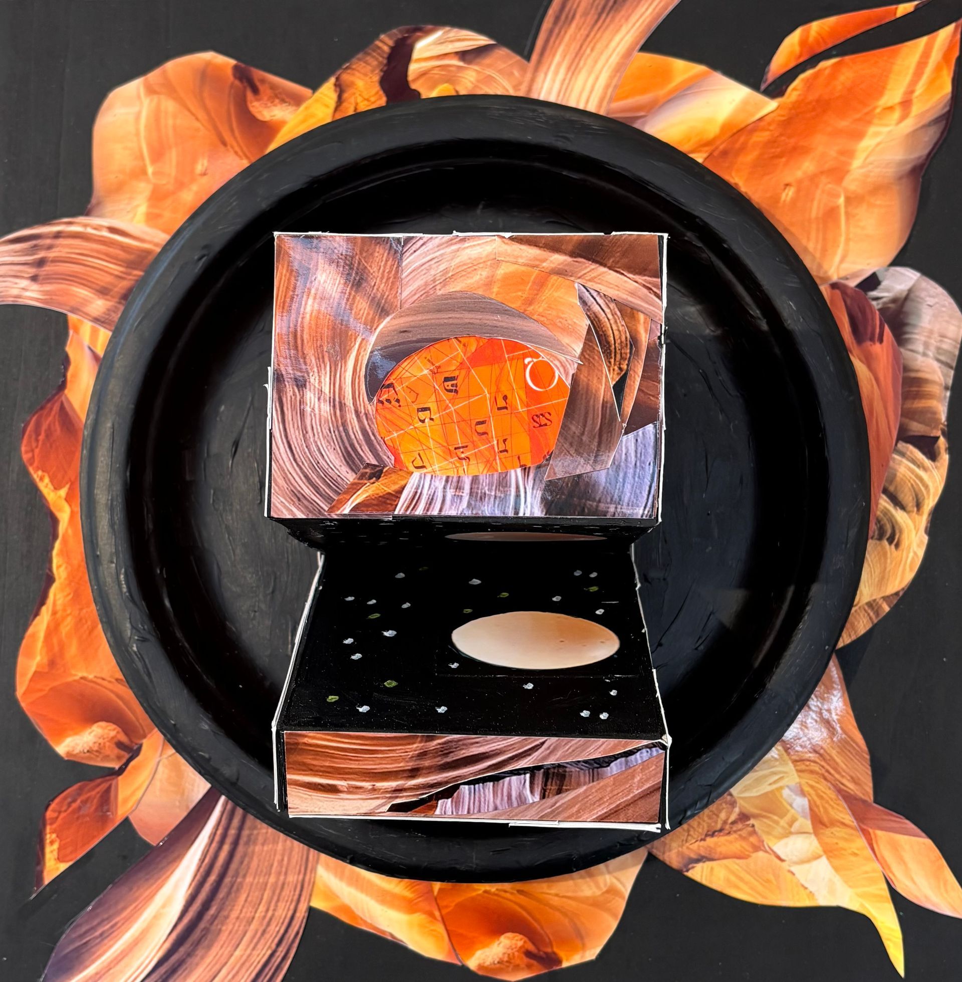 Abstract black circular frame with orange floral background and a small mirrored box in the center.