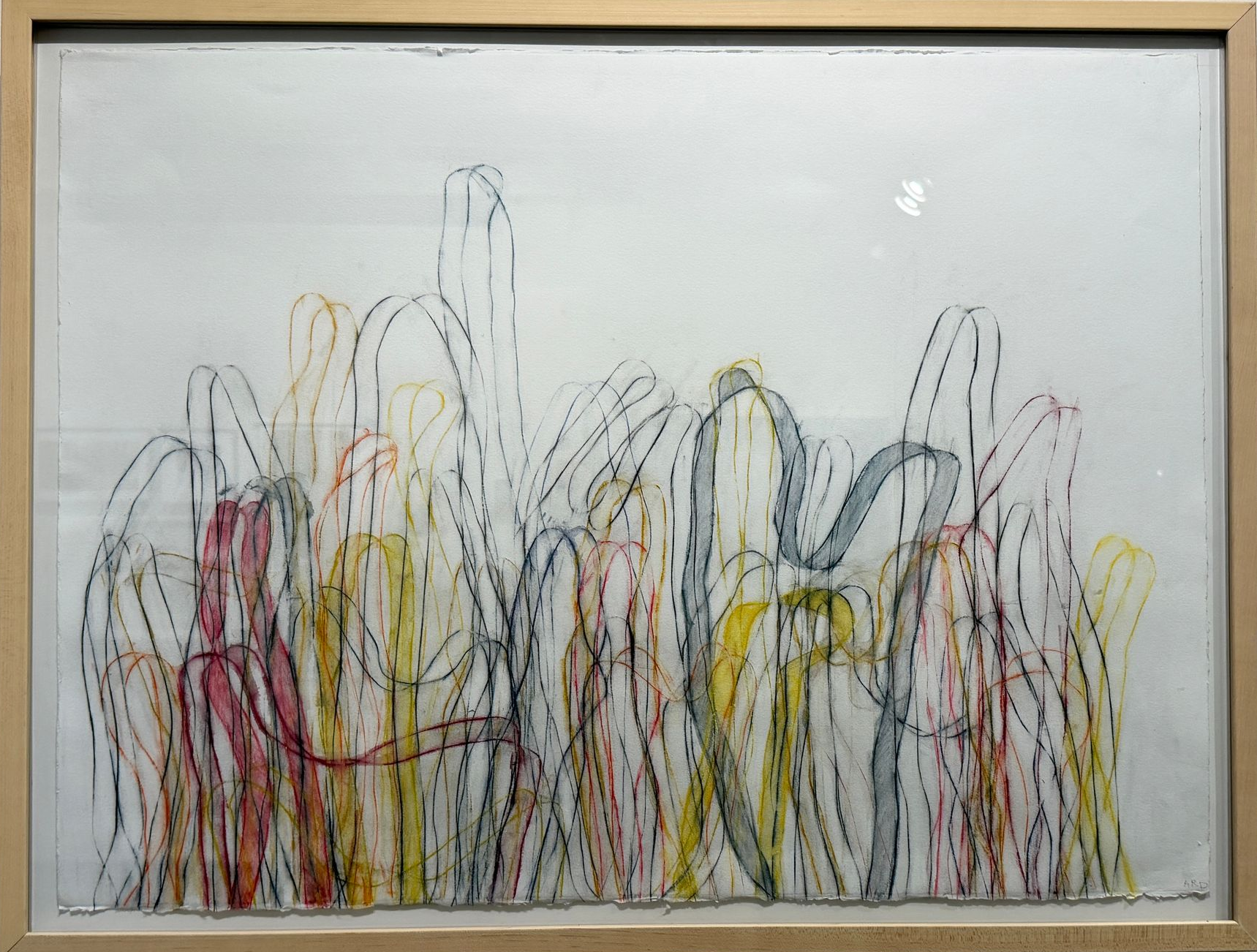 Abstract multicolor sketch of tall, thin arches on a whiteboard, framed in wood