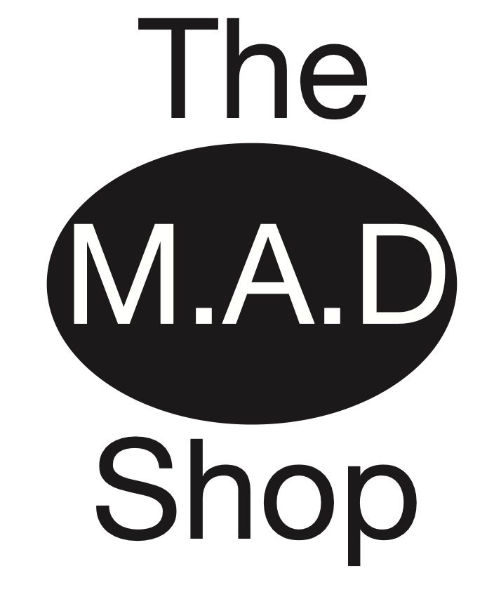 The M.A.D Shop logo: black oval with white “M.A.D” between “The” and “Shop” text on white background