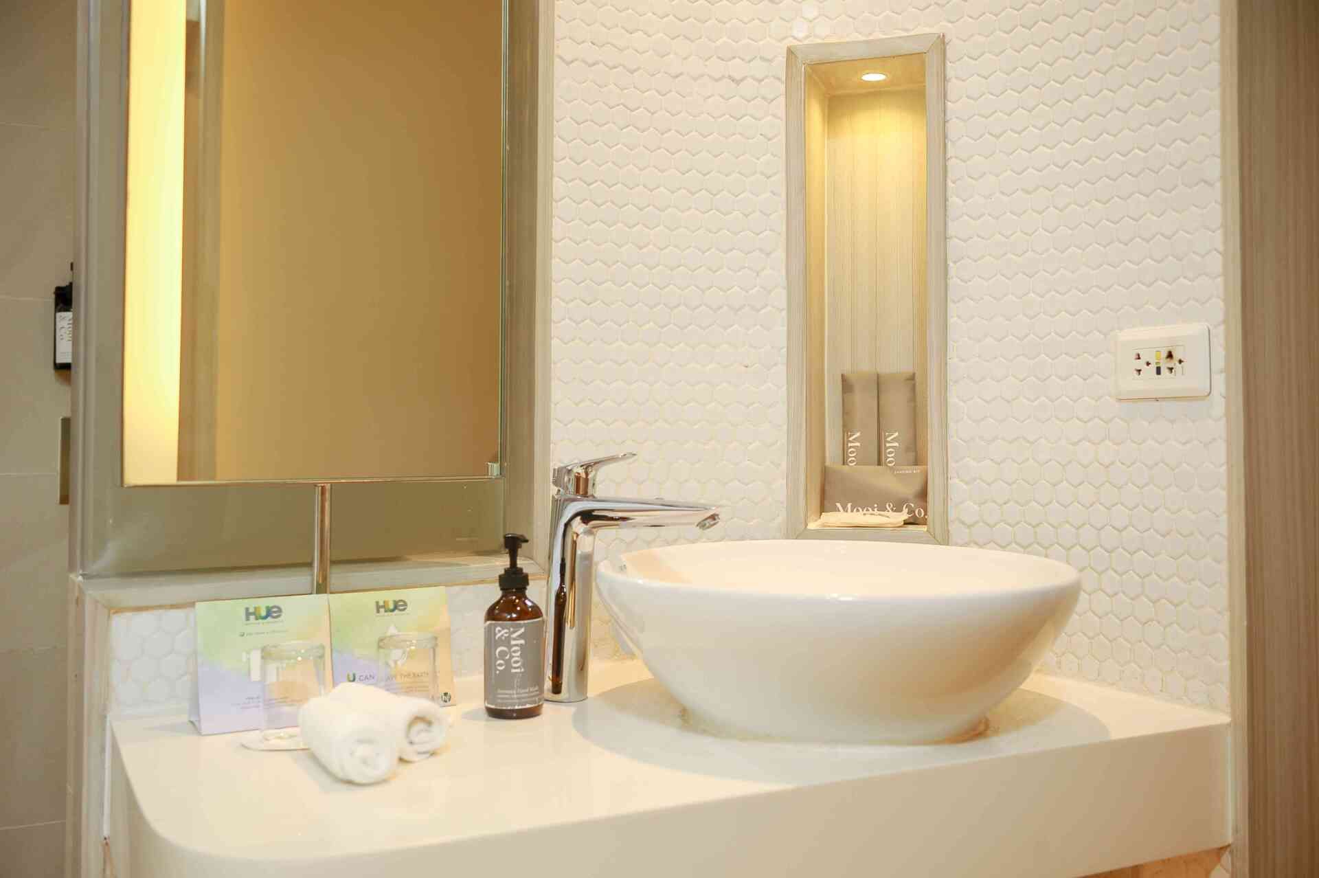 Contemporary bathroom vanity at Hue Hotels Puerto Princesa deluxe room with vessel sink and toiletries