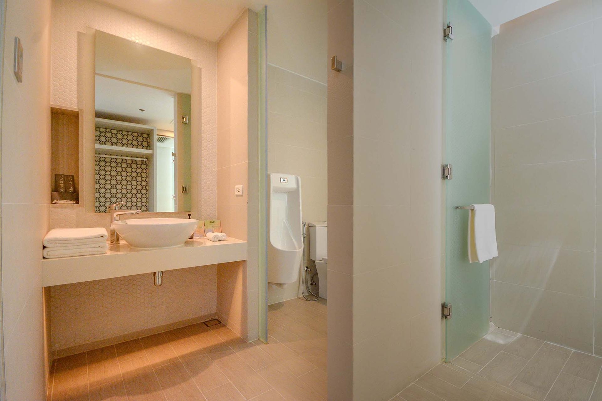 Clean modern bathroom at Hue Hotels Puerto Princesa family suite with glass shower enclosure
