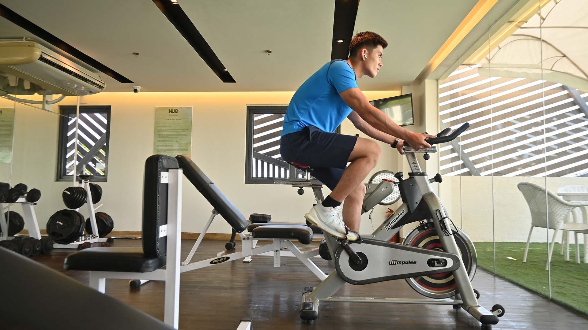 Modern fitness center at Hue Hotels Puerto Princesa hotel with cardio equipment and geometric wall art