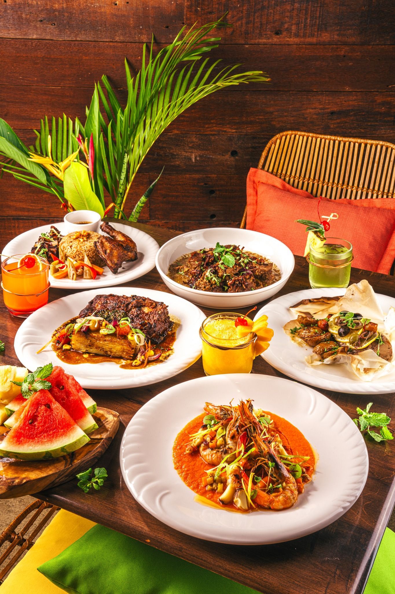 A table topped with plates of food and drinks.