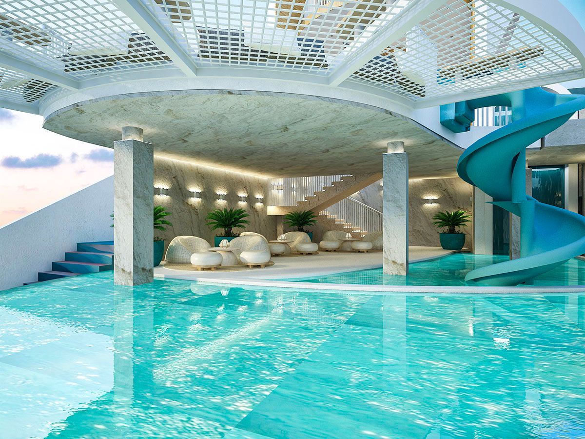 Luxury indoor pool with water slide and lounge at Hue Siargao