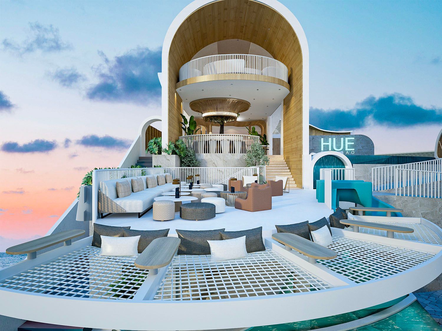 Luxury rooftop lounge with white wicker seating, pool, and ocean view at sunset