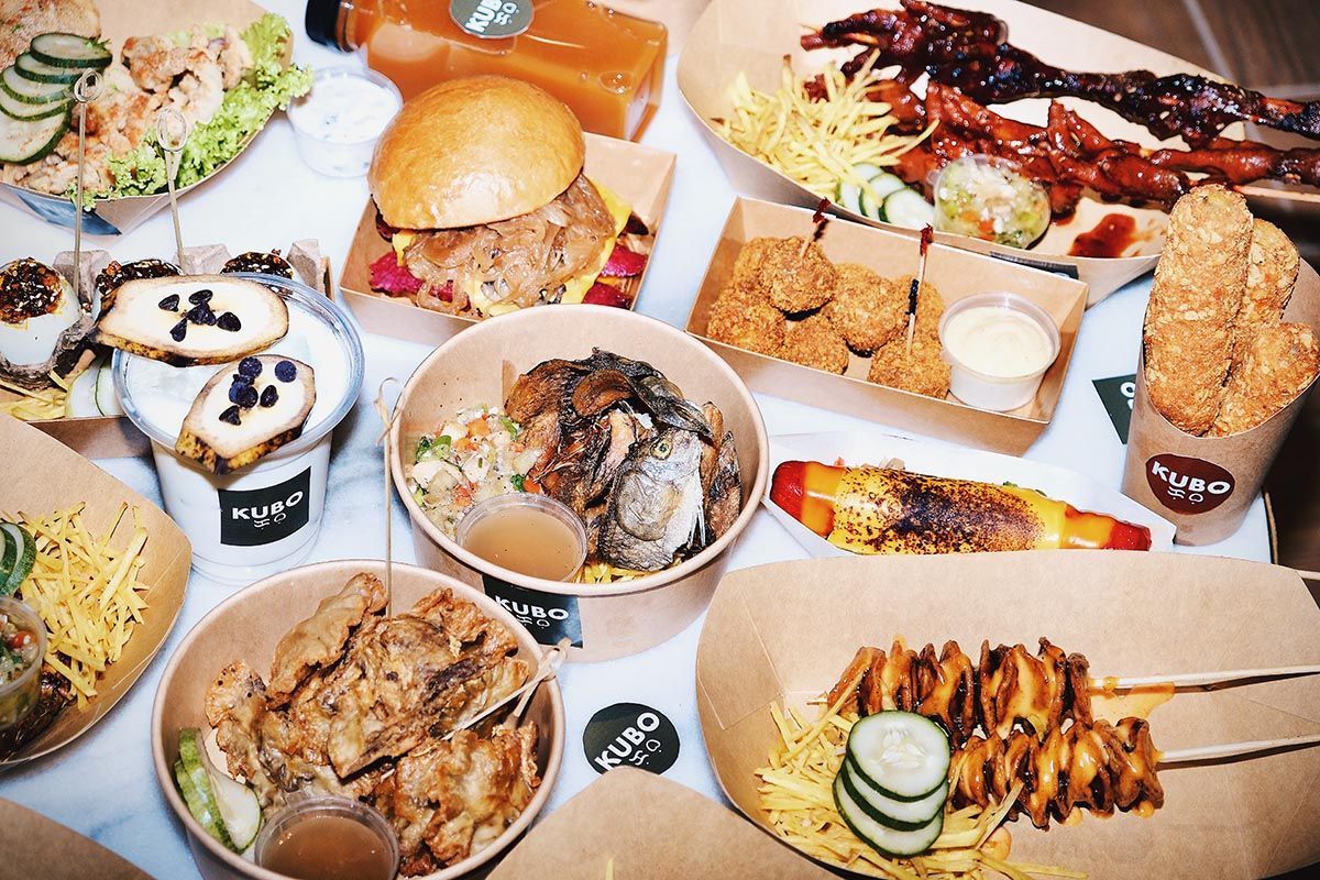 Diverse food selection at Kubo Restaurant Boracay featuring burgers and fresh oysters for family dining