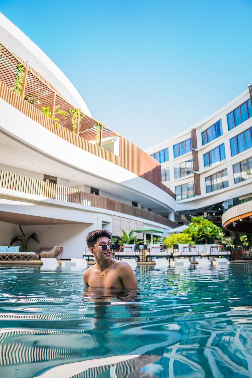 Man relaxing in luxury pool at Hue Hotel Boracay Station 2