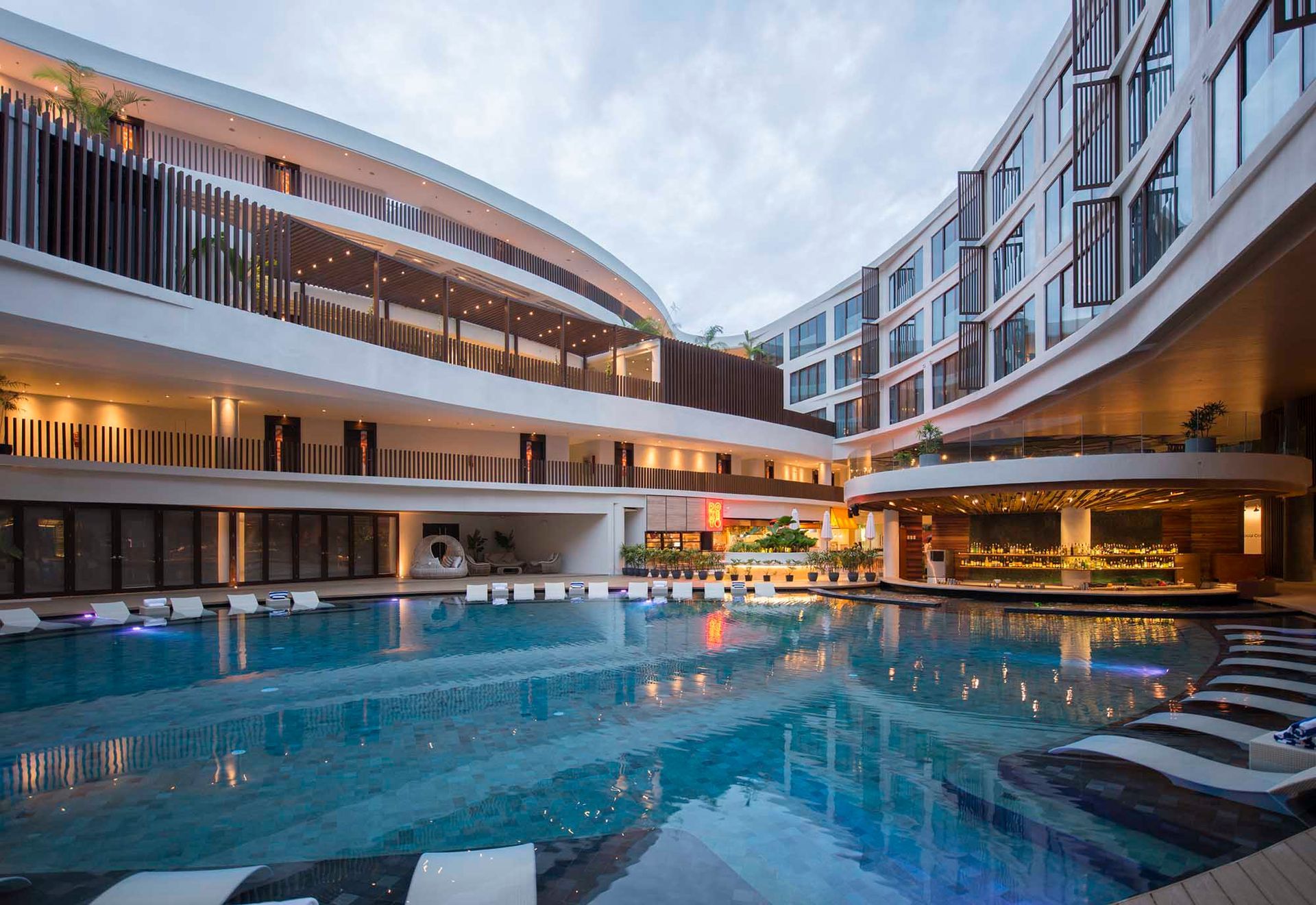 A large swimming pool in the middle of a hotel