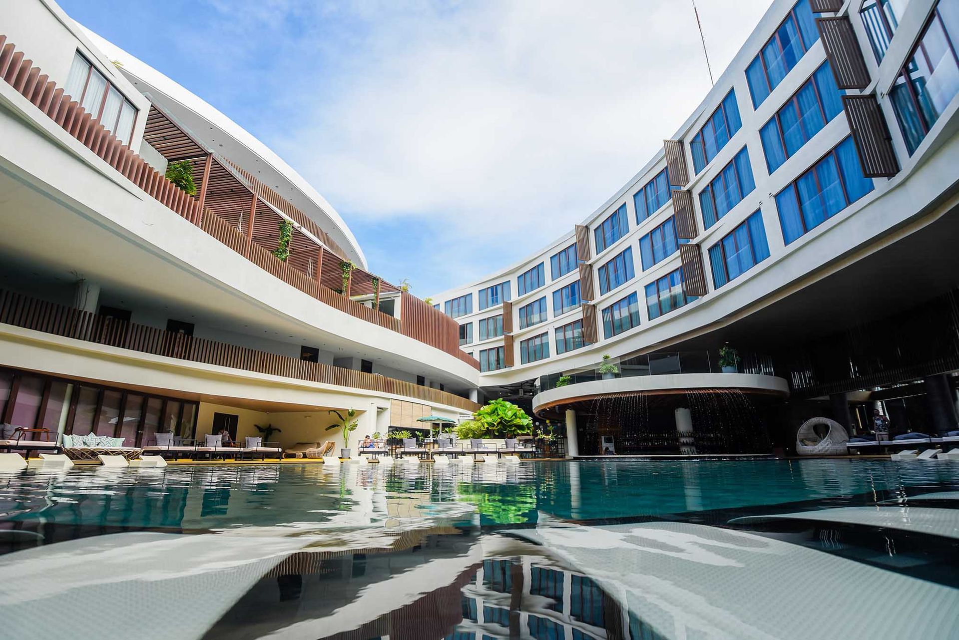 A large building with a swimming pool in front of it