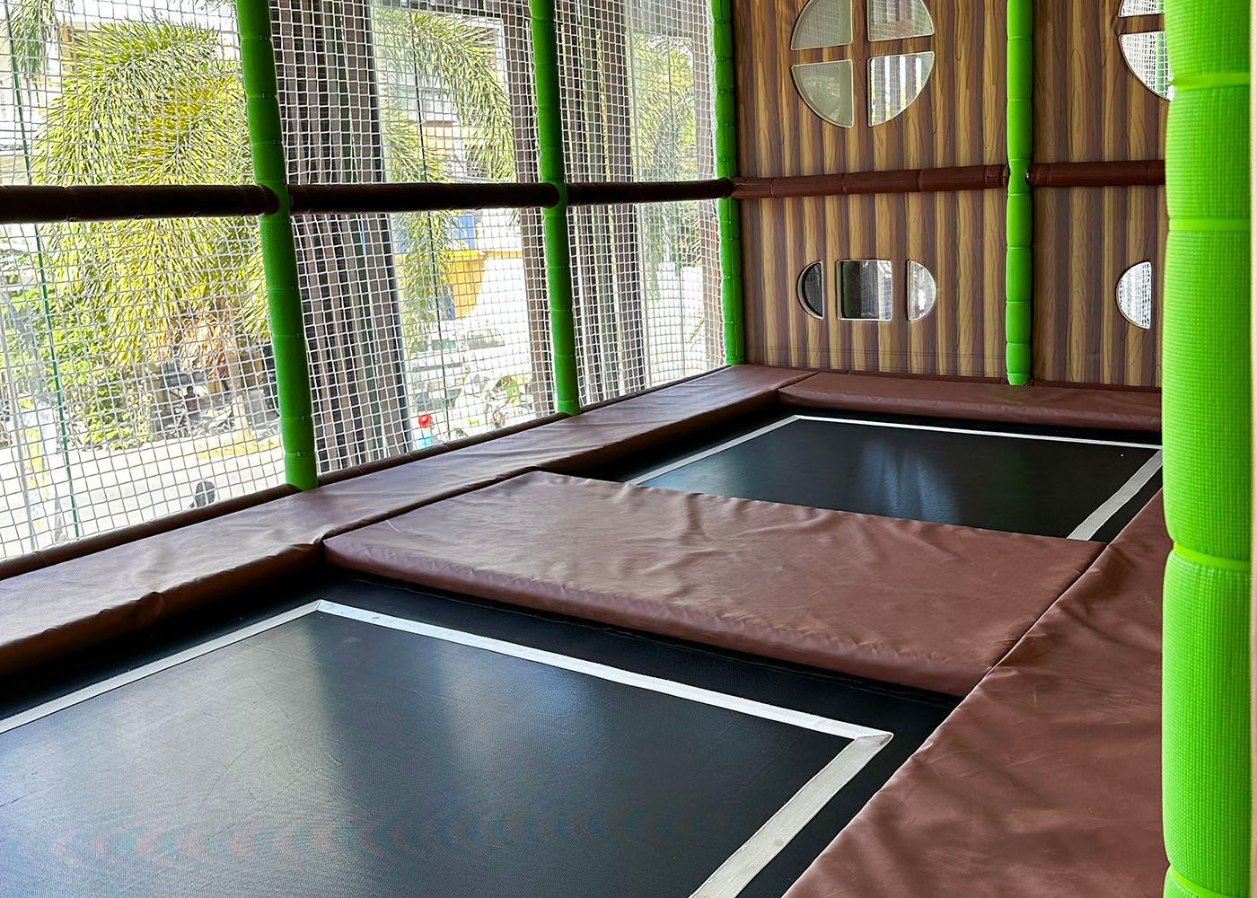 Indoor trampoline park with safety nets and padded mats at Hue Hotel Boraca