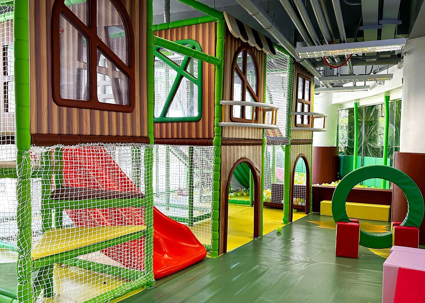 Indoor kids play area with slides, ball pit, and soft foam blocks at Hue Ho