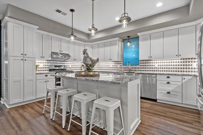 A kitchen with a large island in the middle of it.
