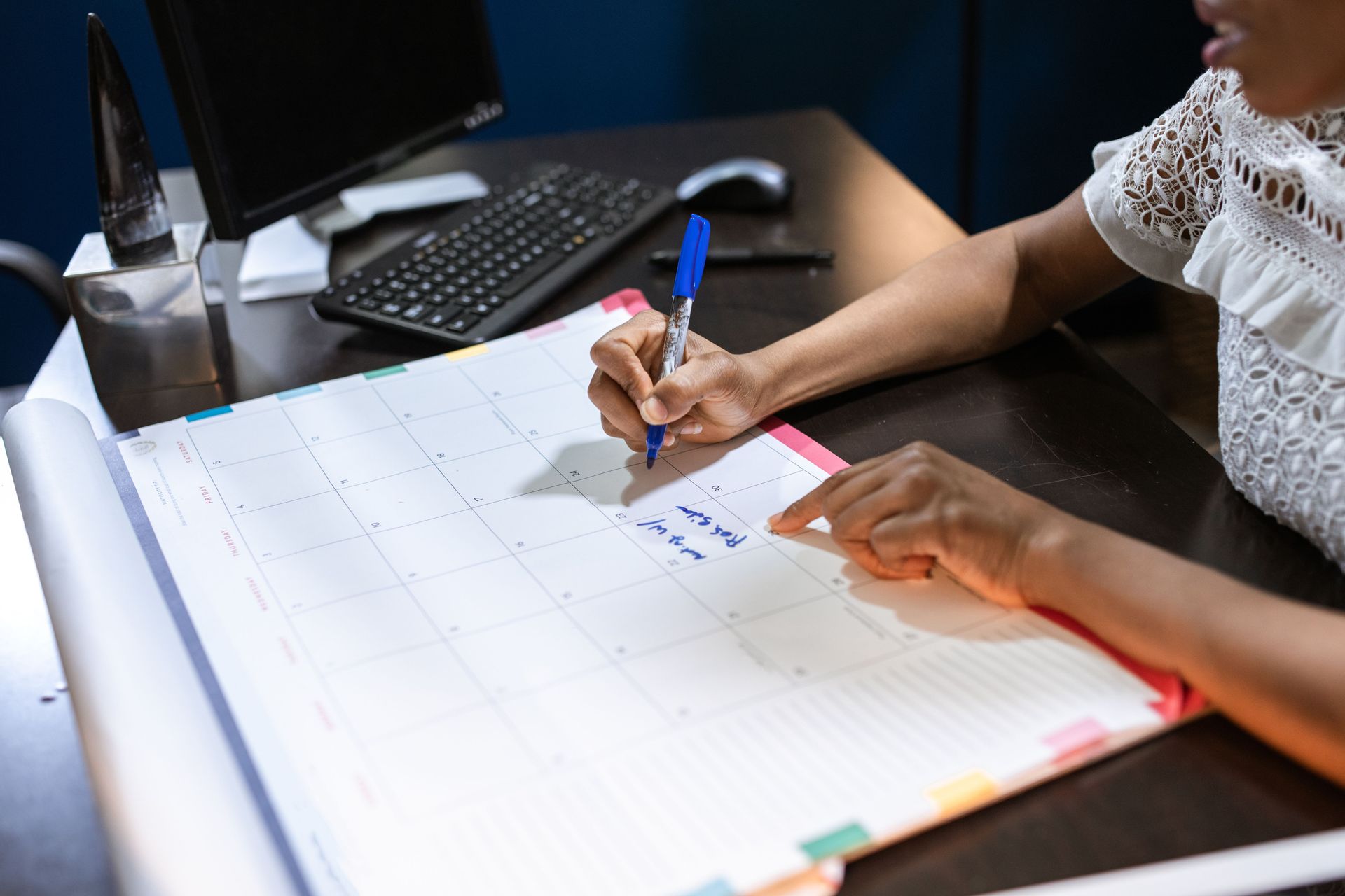 Hand writing plans in a paper planner