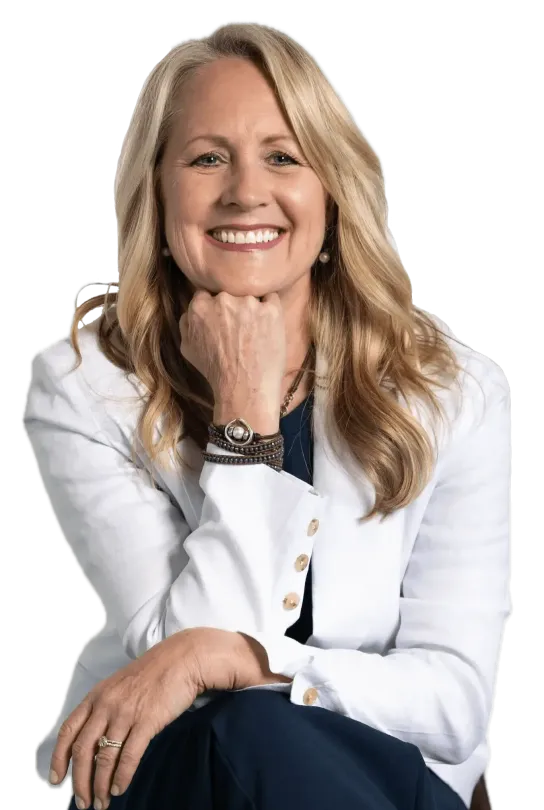 Portrait of a smiling woman in a white blazer, resting her chin on her hand against a white background