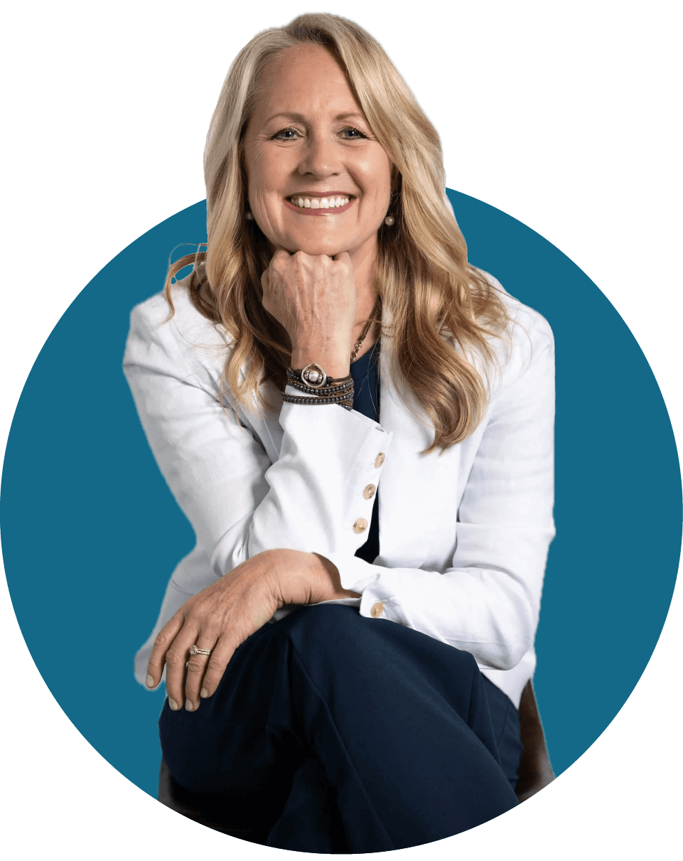 Smiling woman in a white blazer seated against a teal circular background