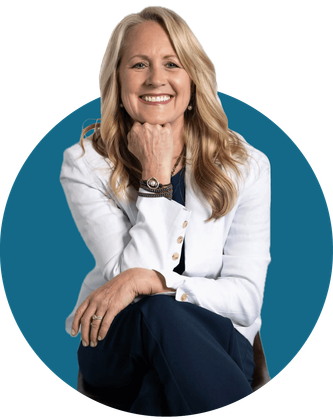 Smiling woman in a white blazer seated against a teal circular background