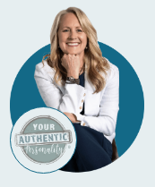 Smiling woman in a white jacket beside a circular logo reading “Your Authenticity Unleashed”