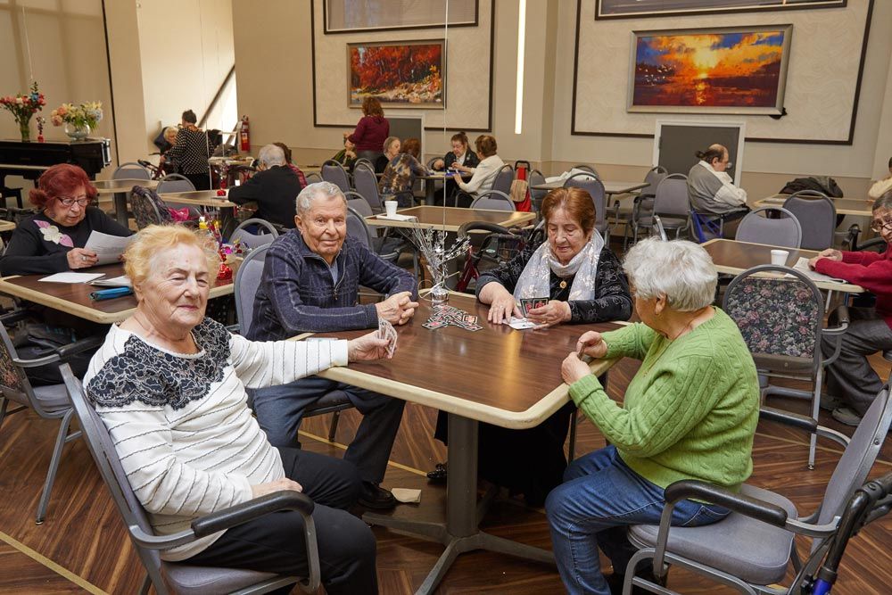 A group of seniors at a assisted living community playing cards