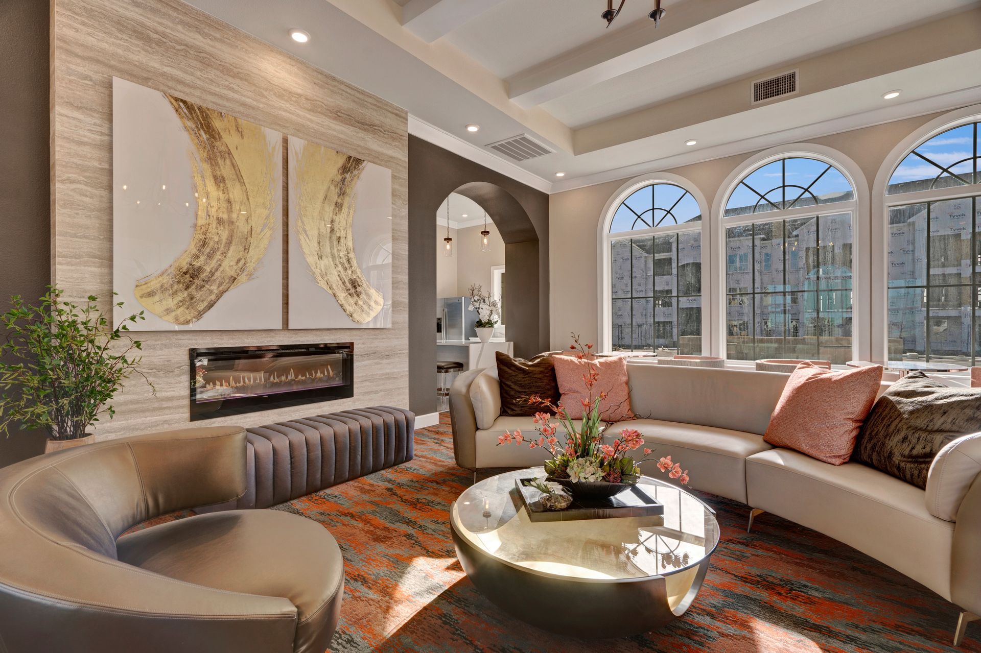A living room with a couch , chair , coffee table and fireplace.