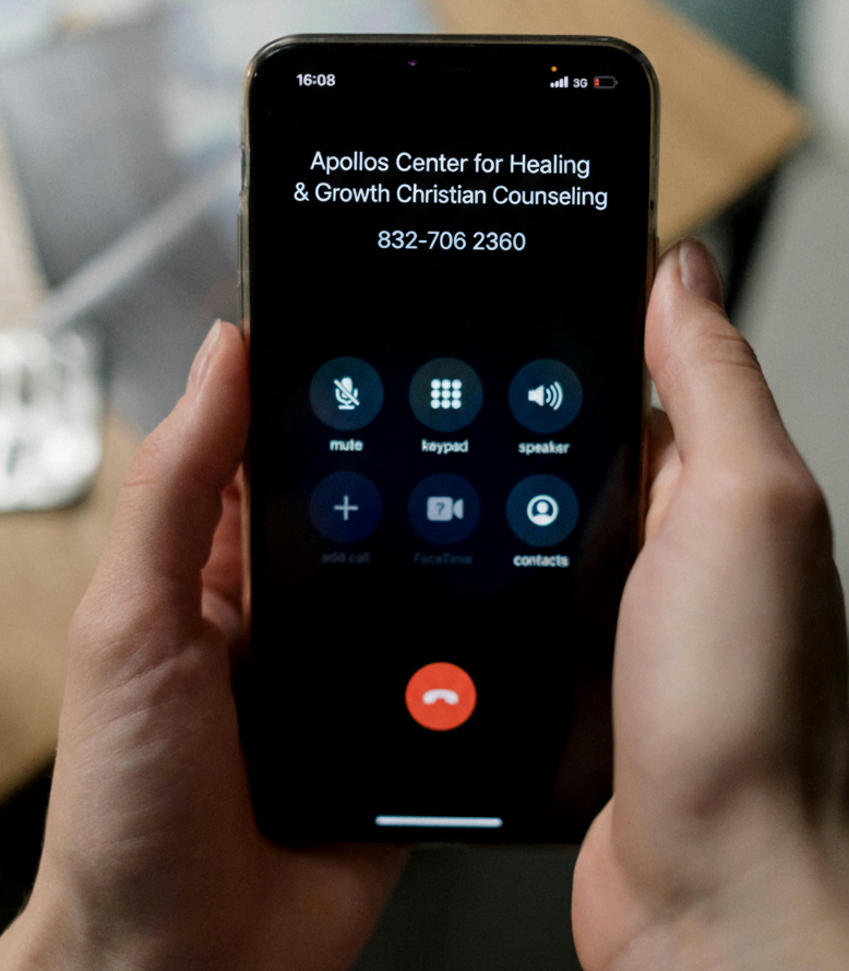 Phone screen showing a call to Apollos Center for Healing & Growth Christian Counseling. Hand holds the phone.