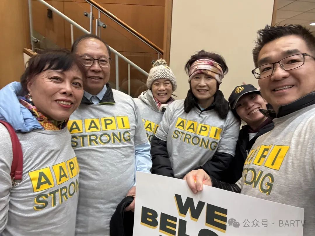 A group of people wearing aapi strong shirts are posing for a picture.
