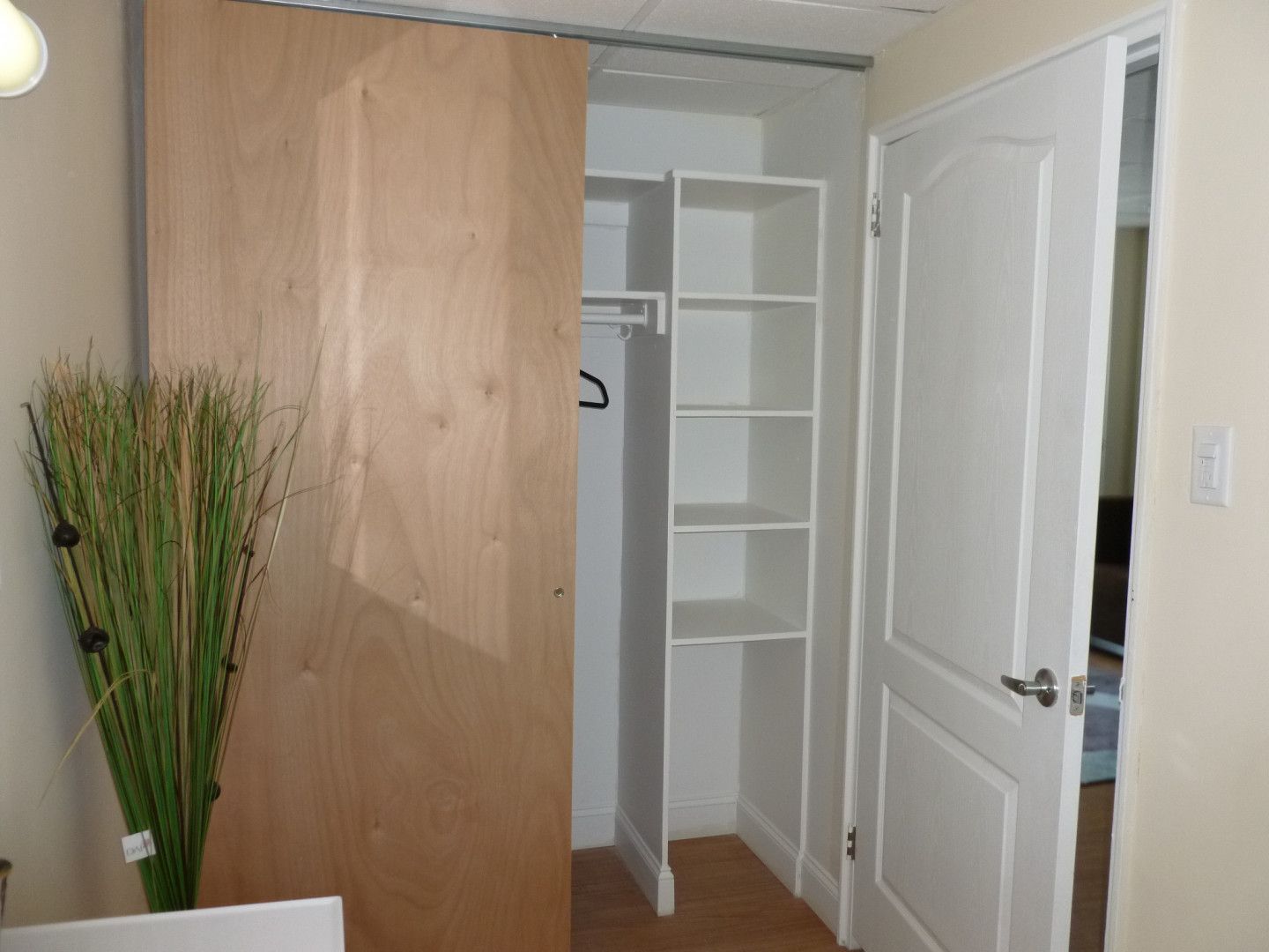 A closet with shelves and a sliding door