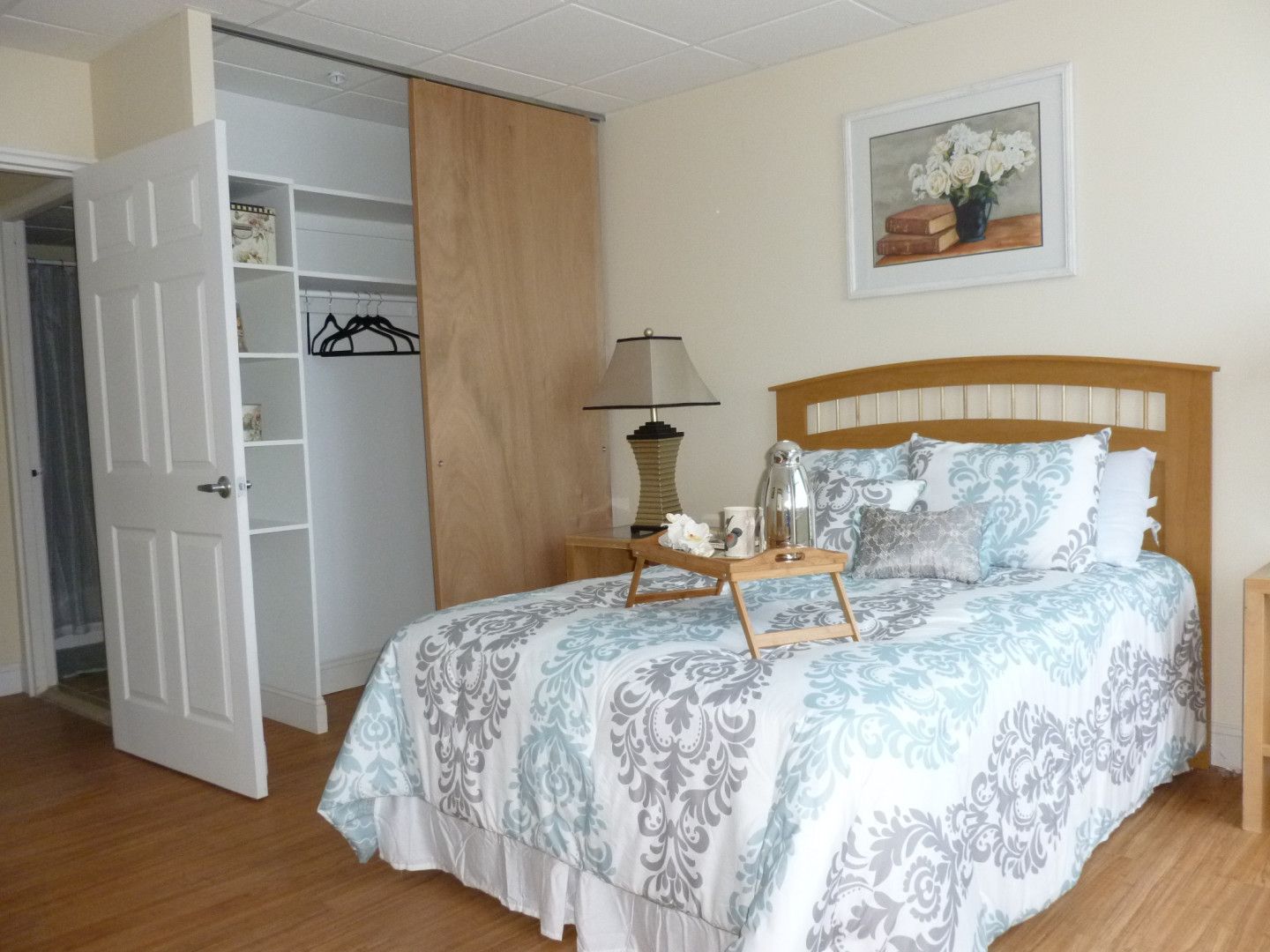 A bedroom with a bed and a tray on it