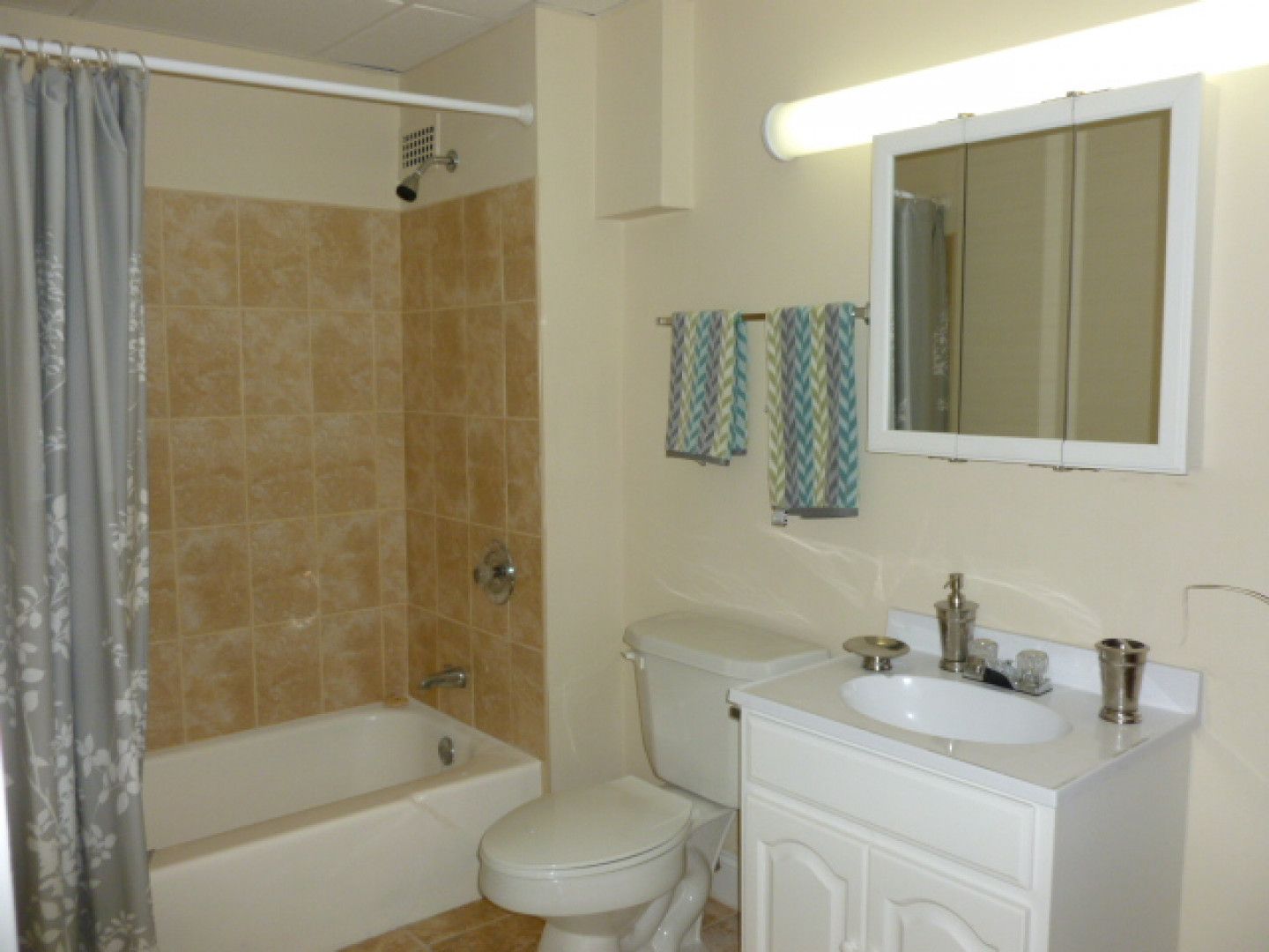 A bathroom with a toilet a sink and a bathtub