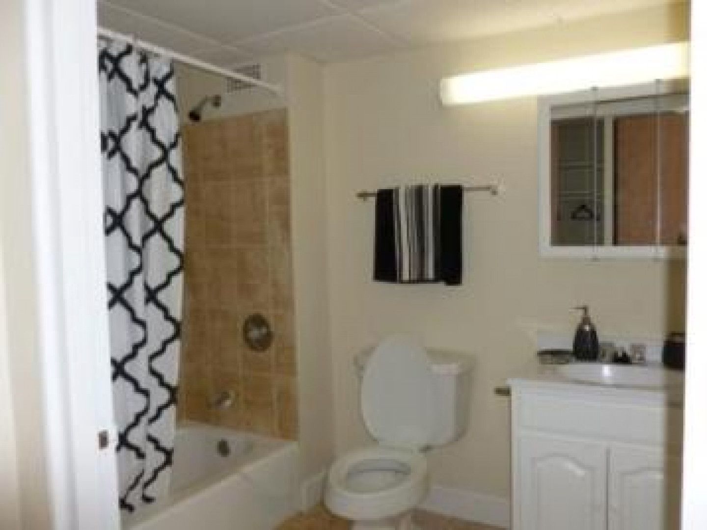 A bathroom with a toilet a sink and a bathtub