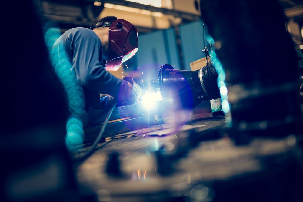 Welder in Red Helmet Welding Metal in a Workshop, Bright Sparks — GC Custom Fabrication in Molendinar, QLD