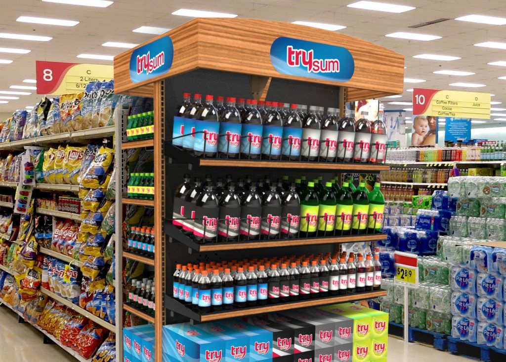 Aisle display of bottled drinks and snacks in a grocery store, with colorful shelves and product signage.