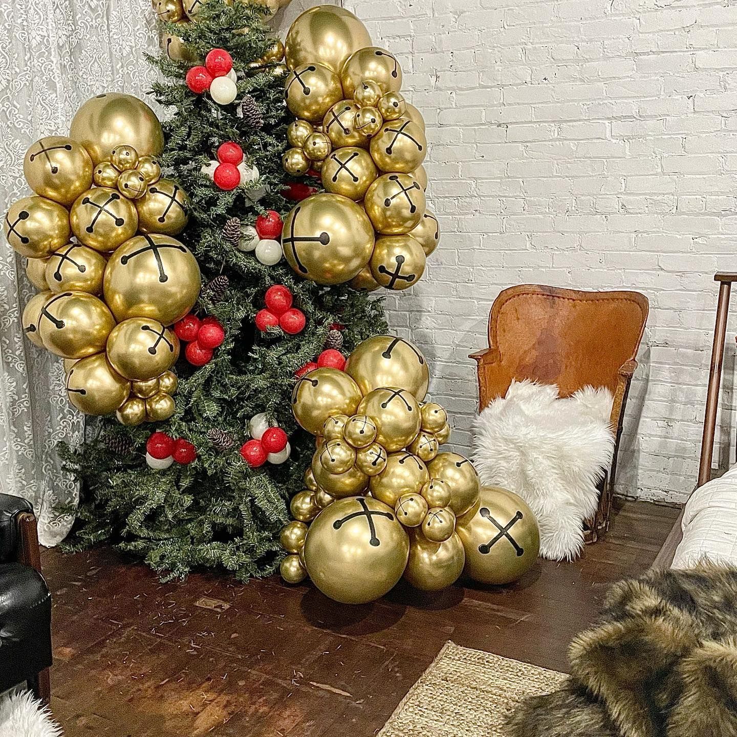 A Christmas tree is decorated with gold bells and red berries.